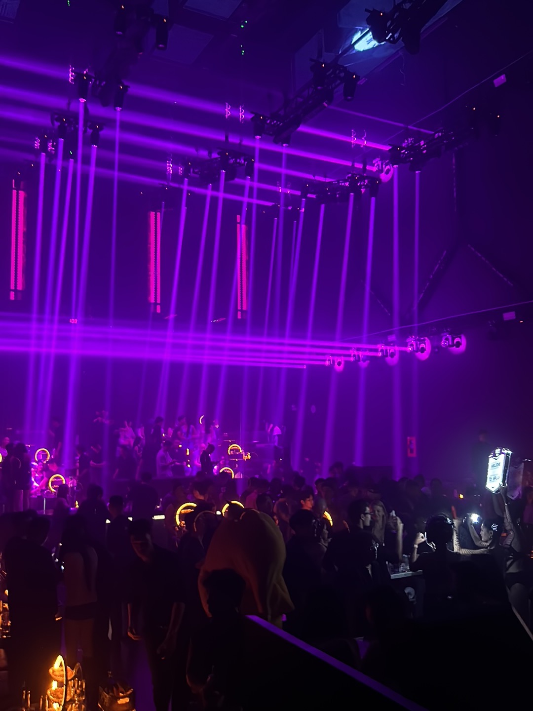 A packed crowd at APLUS Saigon under the violet rig