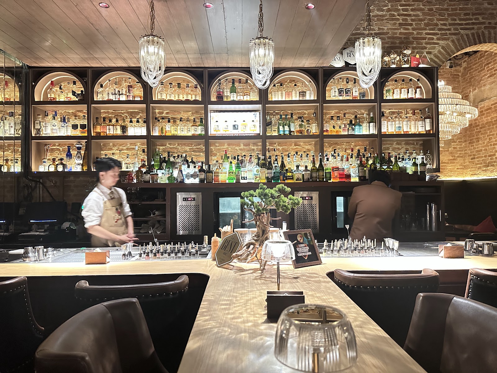 Bartenders at work behind the bar at The Enigma Mansion