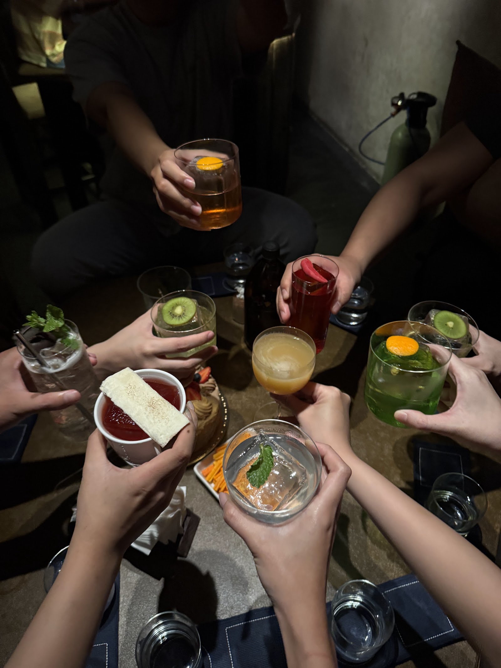 Two cocktails raised — a toast at Hybrid Saigon