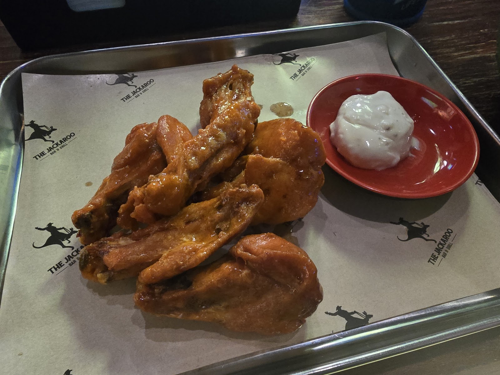Glazed chicken wings on branded Jackaroo tray paper