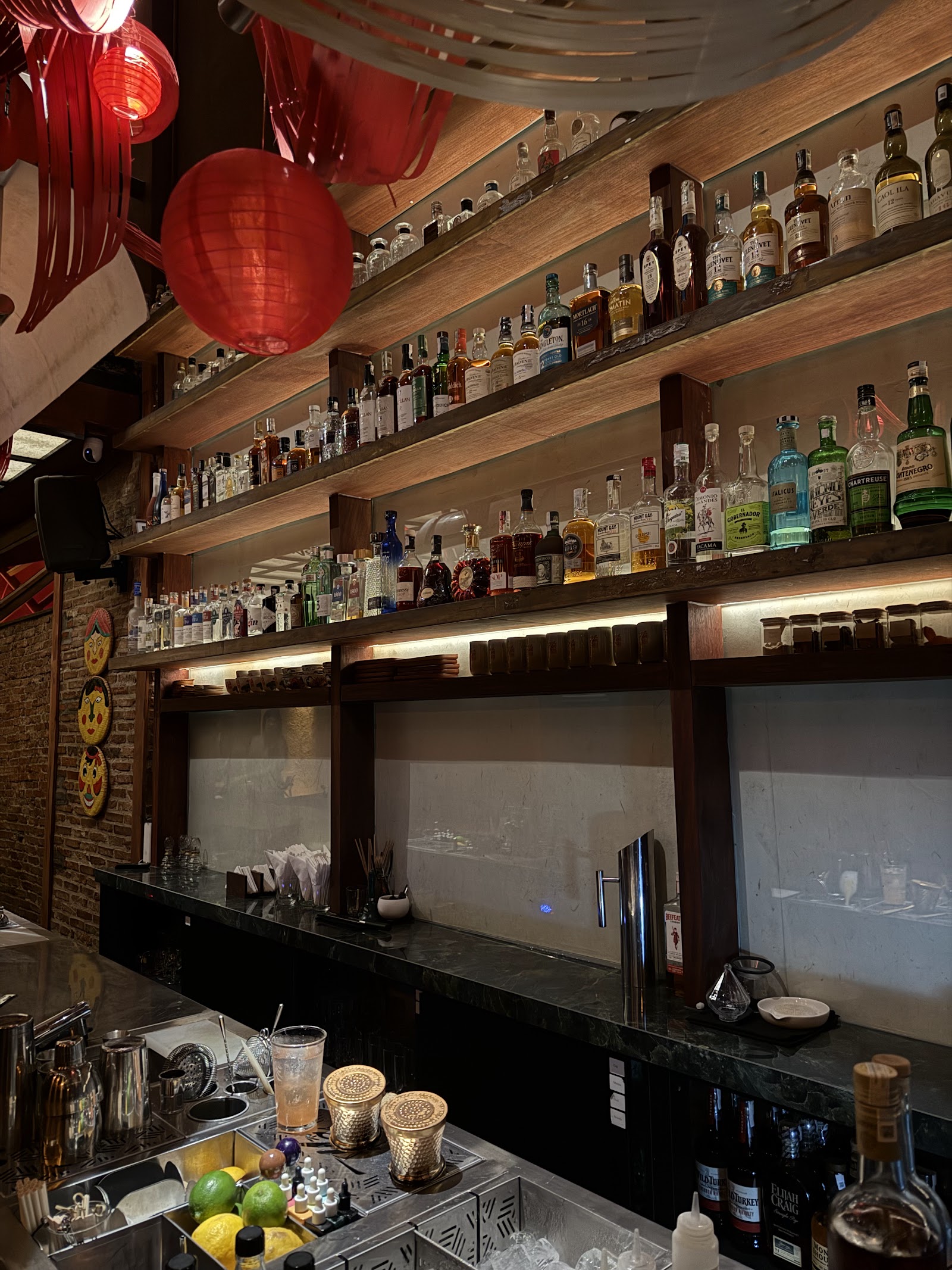 The lit back-bar shelves at Nê