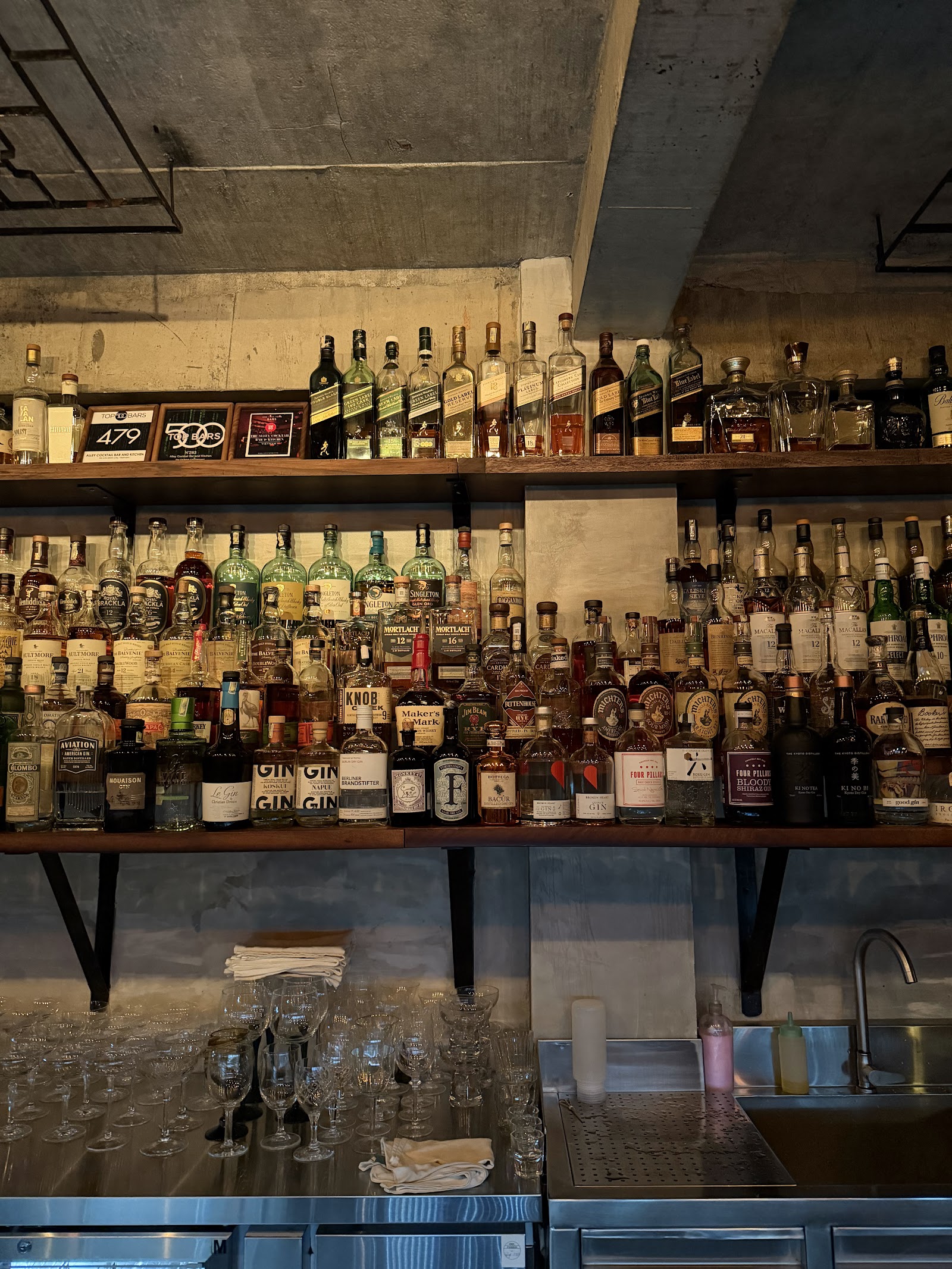 The Alley bar shelves — bottles behind the counter