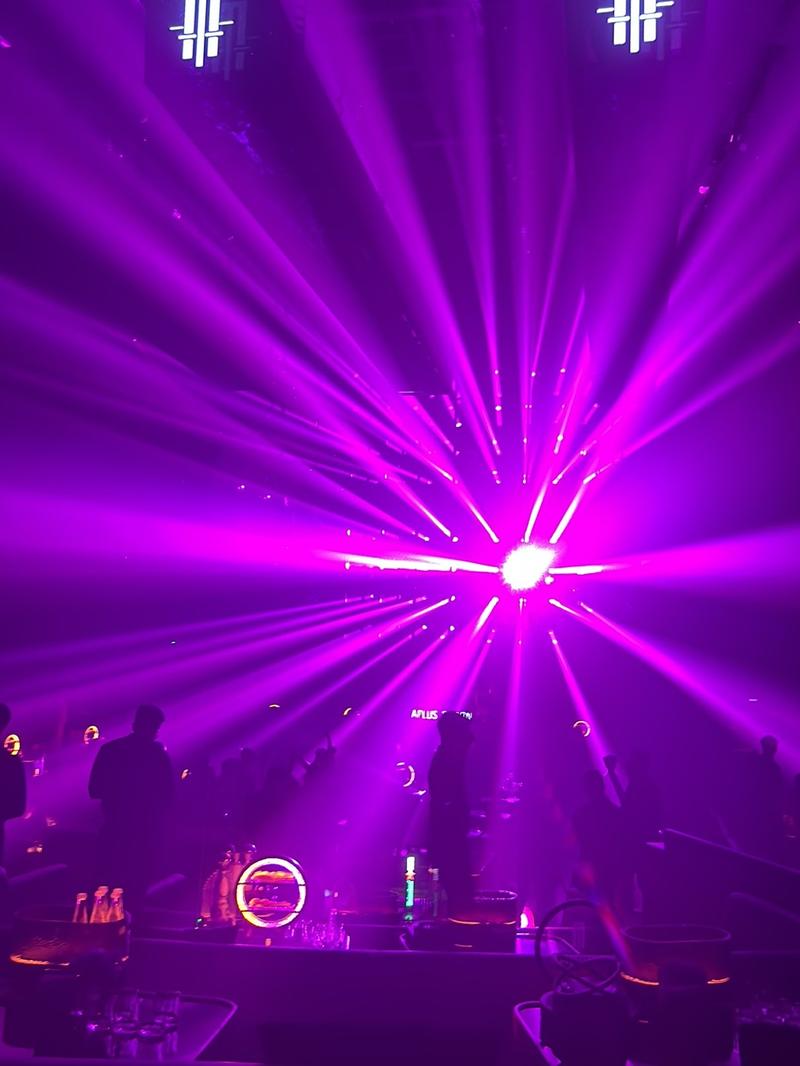 A magenta beam burst mid-room at APLUS Saigon