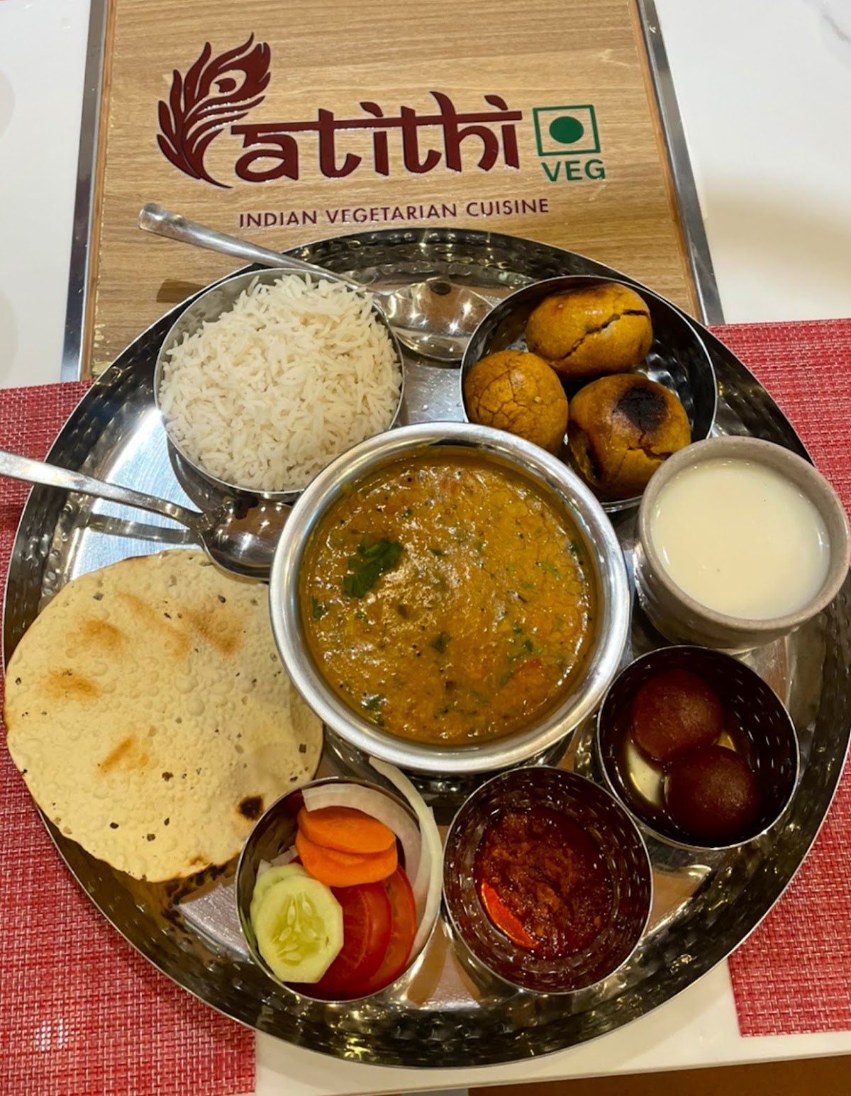 Steel thali on the branded atithi wooden board