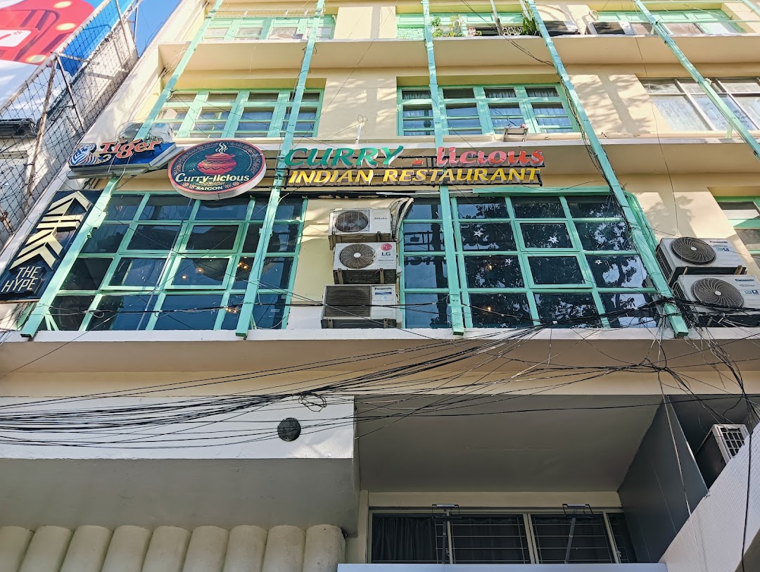 Storefront — CURRY–licious sign, ground-floor glass doors