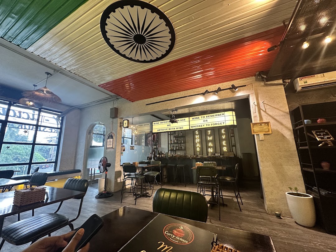 Wide dining room — flag-coloured ceiling, Ashoka Chakra, bar