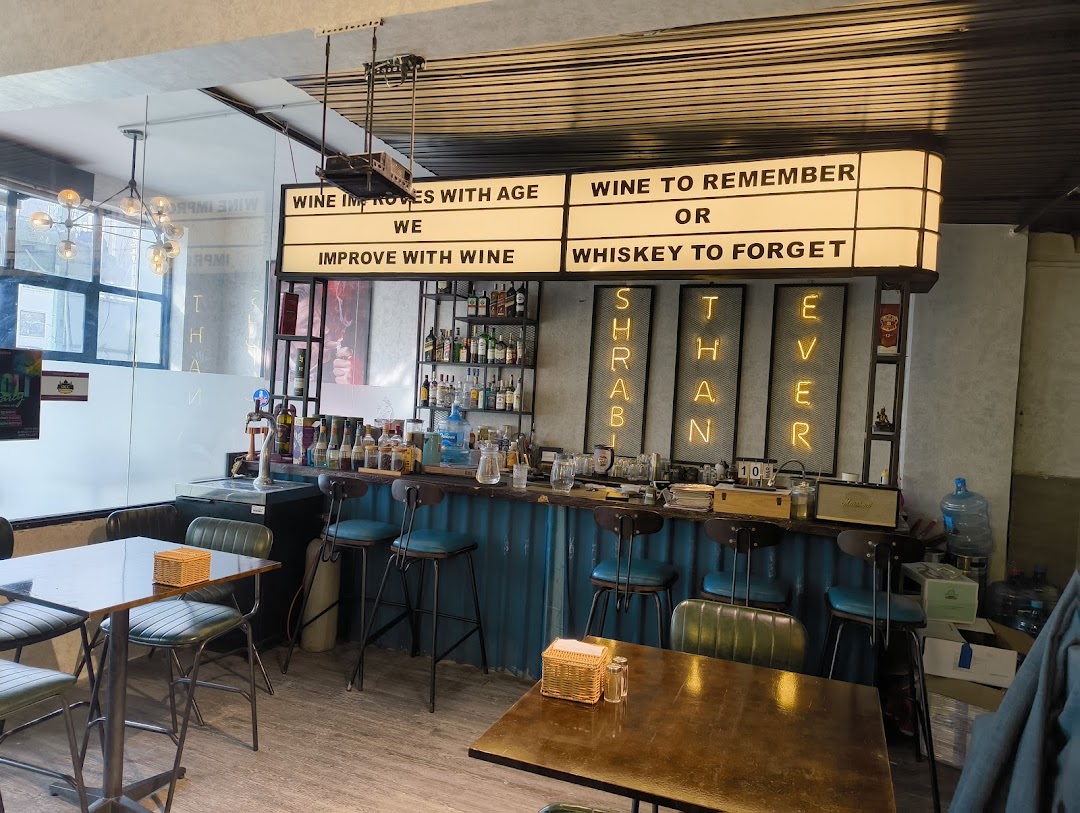 Bar — cinema marquee and SHRABI THAN EVER neon