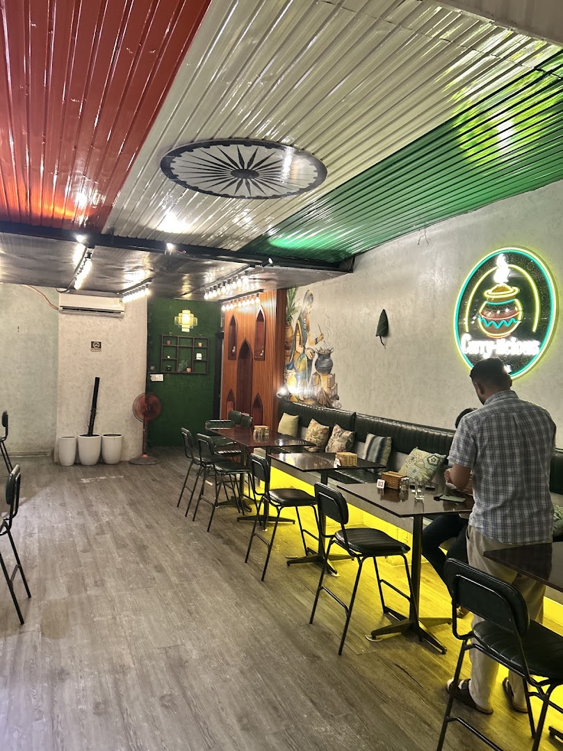 Long hall — neon logo, mural, yellow LED-lit tables