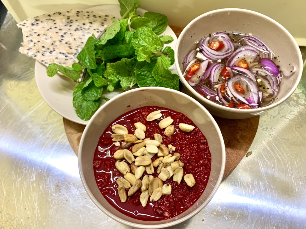 Goat blood soup with peanuts, pickled red onions, herbs and sesame crackers