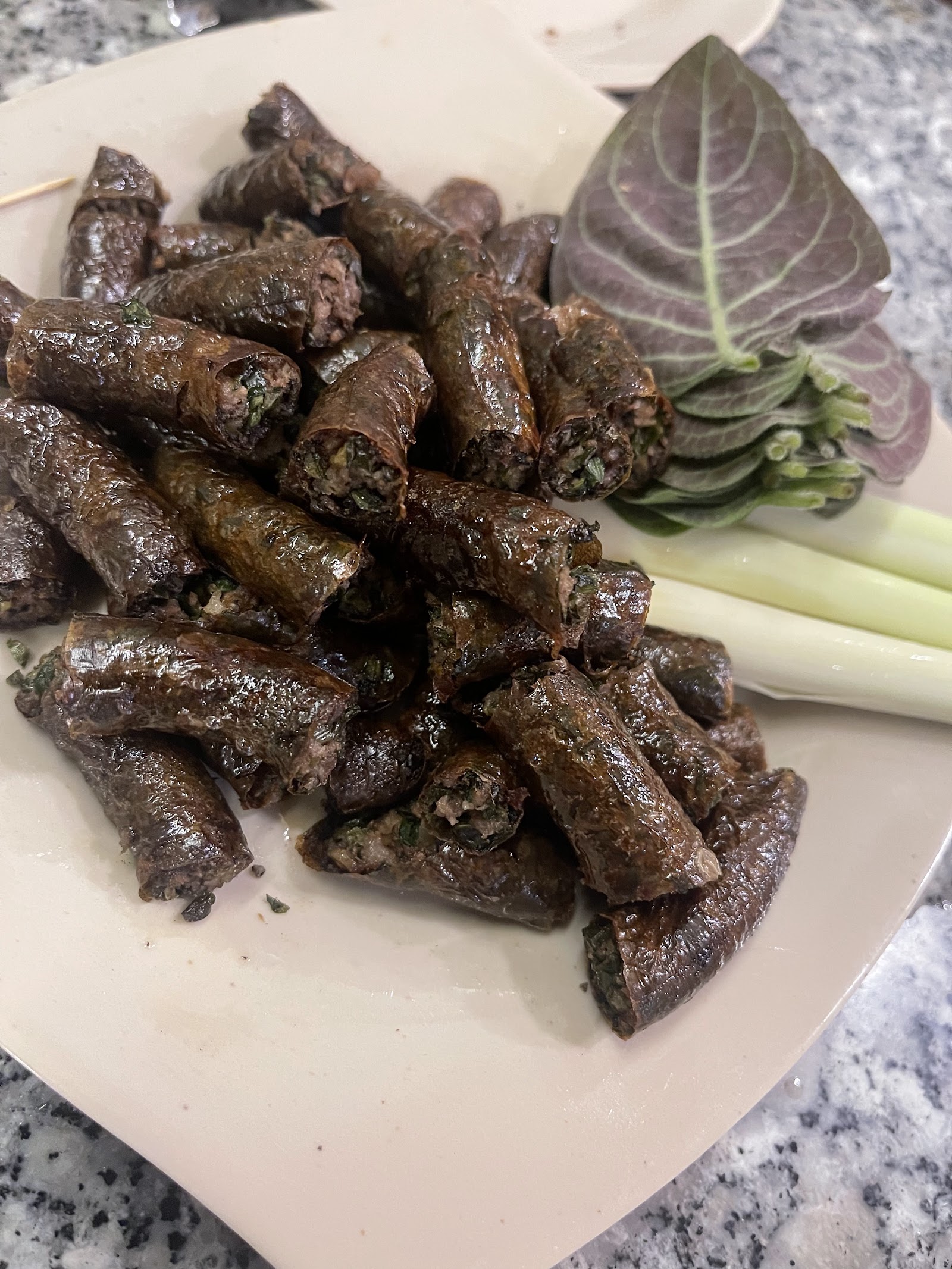 Grilled stuffed goat rolls with perilla leaves and lemongrass