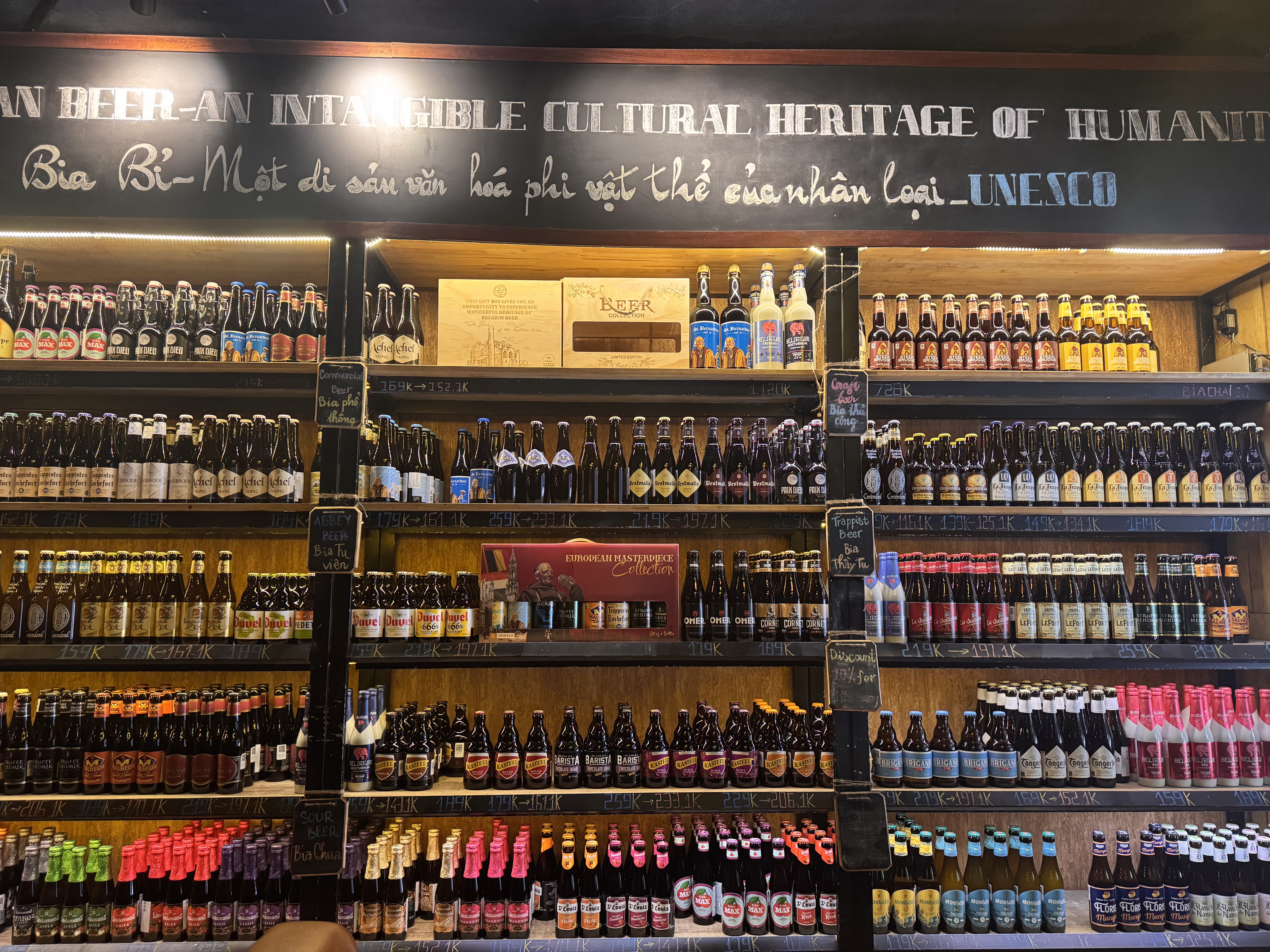 Signature bottle wall under the UNESCO chalkboard