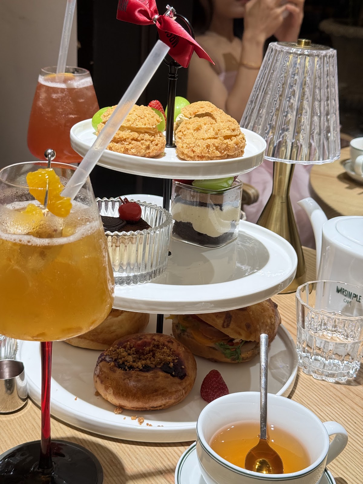 Afternoon tea set — tiered pastry stand, cocktails, teacup, crystal lamp